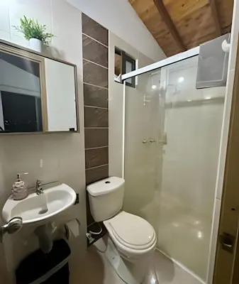 a bathroom with a toilet and a sink and a shower at beautiful view of the city with local experience in Envigado