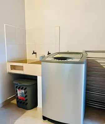 a small kitchen with a refrigerator and a sink at Duplex con terraza en el corazón de Envigado 300mb in Envigado