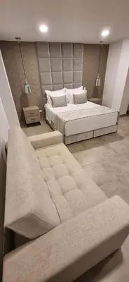 a large bedroom with two beds and a couch at Hotel 45 Park in Sabaneta