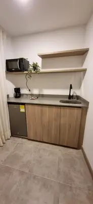 a kitchen with a sink and a counter top at Hotel 45 Park in Sabaneta