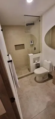 a bathroom with a toilet and a sink at Hotel 45 Park in Sabaneta