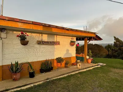 a building with potted plants on the side of it at Santaelena Cielo · Retiro natural cerca al Parque Arví Wi-Fi Starlink in Medellín