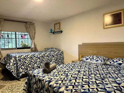 a bedroom with two beds and a window at Santaelena Cielo · Retiro natural cerca al Parque Arví Wi-Fi Starlink in Medellín