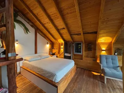 a bedroom with a bed and a blue chair at PrivaDune in Rionegro