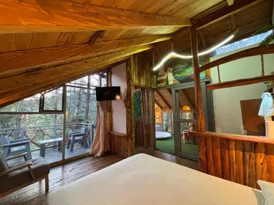 a bedroom with a bed and a large window at PrivaDune in Rionegro