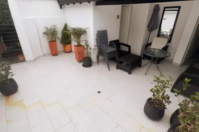a patio with potted plants and a table and chairs at Casa de Ensueño El Poblado in Medellín