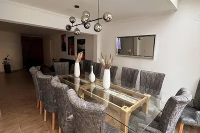 a dining room with a glass table and chairs at Casa de Ensueño El Poblado in Medellín