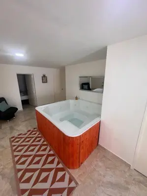 a large bath tub in a room with a room with a bedroom at Casa de Ensueño El Poblado in Medellín