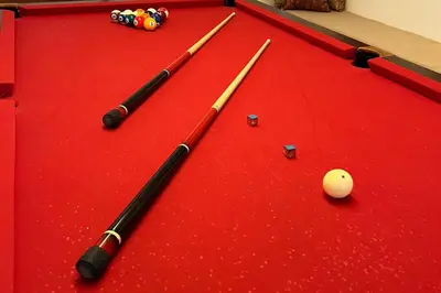 three cue balls on a red felt pool table at Casa de Ensueño El Poblado in Medellín