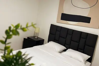 a bedroom with a bed with a black head board at Casa de Ensueño El Poblado in Medellín
