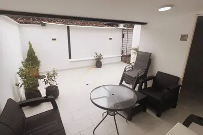 a room with chairs and a table and a screen at Casa de Ensueño El Poblado in Medellín