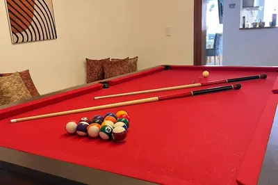 a red pool table with balls and bats on it at Casa de Ensueño El Poblado in Medellín
