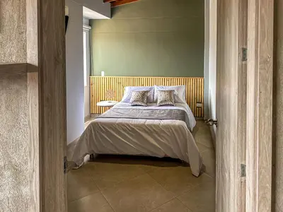 a bedroom with a bed and a window at Edificio Atalanta en el corazón de Medellín in Medellín