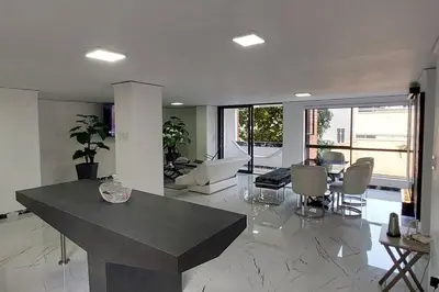 a large living room with a table and chairs at Apartamento Ejecutivo El Poblado Renta Larga 28 dias Amueblado WiFi in Medellín