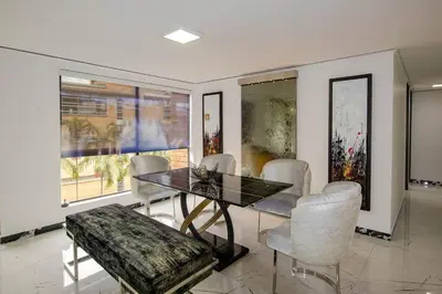 a dining room with a glass table and chairs at Apartamento Ejecutivo El Poblado Renta Larga 28 dias Amueblado WiFi in Medellín