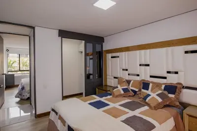 a bedroom with a large bed in a room at Apartamento Ejecutivo El Poblado Renta Larga 28 dias Amueblado WiFi in Medellín
