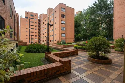 a courtyard with brick buildings and trees and bushes at Apartamento Ejecutivo El Poblado Renta Larga 28 dias Amueblado WiFi in Medellín