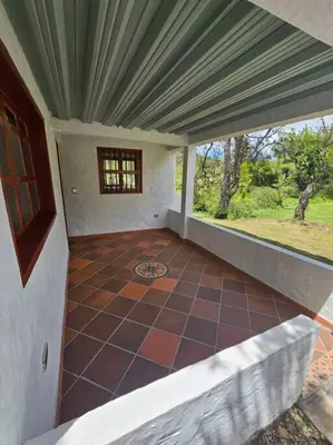 an empty porch of a house with a tiled floor at Tranquilidad y Naturaleza Cabaña Concepción in Concepción