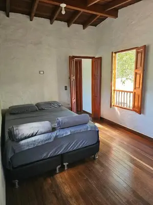 a bedroom with a bed in a room with a window at Tranquilidad y Naturaleza Cabaña Concepción in Concepción