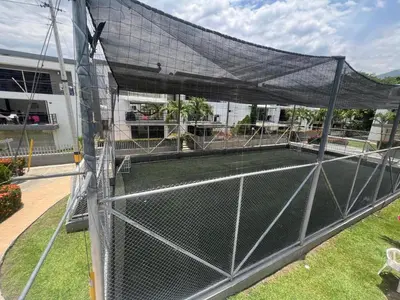 a tennis court with a net in a yard at Ciudadela Santa Fe in Santa Fe de Antioquia