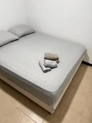 a bed with two towels sitting on top of it at Ciudadela Santa Fe in Santa Fe de Antioquia