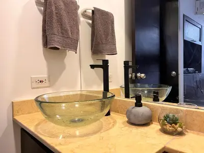 a bathroom with a glass bowl on a counter at Ciudadela Santa Fe in Santa Fe de Antioquia