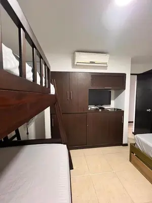 a living room with a bunk bed and a television at Ciudadela Santa Fe in Santa Fe de Antioquia
