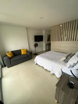 a bedroom with a bed and a couch at Moderno Apartamento en Sabaneta cerca al parque in Sabaneta