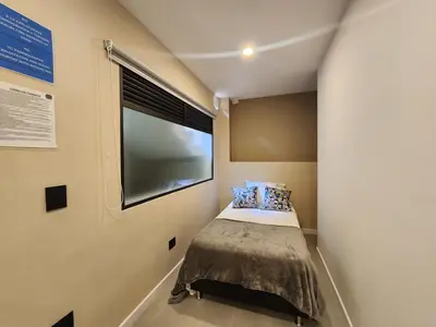 a small bedroom with a bed and a window at Loft 10, Comodo Aparta estudio 201 in Medellín