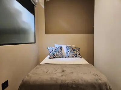 a bedroom with a bed with two pillows on it at Loft 10, Comodo Aparta estudio 201 in Medellín