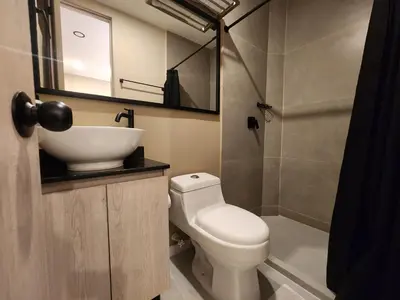 a small bathroom with a sink and a toilet at Loft 10, Comodo Aparta estudio 201 in Medellín