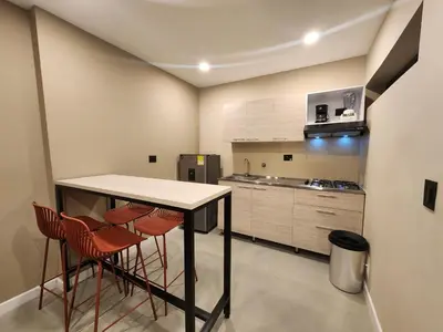 a kitchen with a table and four chairs at Loft 10, Comodo Aparta estudio 201 in Medellín