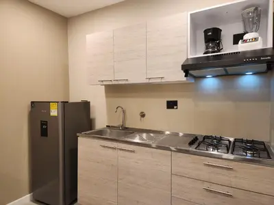 a kitchen with a sink and a refrigerator at Loft 10, Comodo Aparta estudio 201 in Medellín