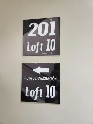 a sign hanging on a wall with the number left at Loft 10, Comodo Aparta estudio 201 in Medellín