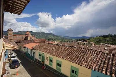 an overhead view of a city with buildings and mountains at La Oculta Hostal in Jericó