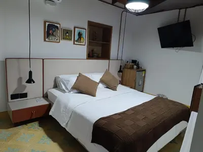a bedroom with a bed and a tv on the wall at Hotel Nuss in San Roque