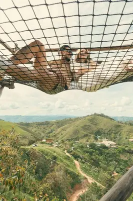two people are looking out over a valley from a mountain at Hotel Nuss in San Roque