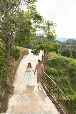 a bride and groom walking down a path at Hotel Nuss in San Roque