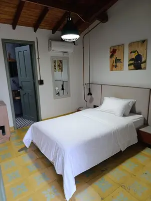 a bedroom with a large white bed in a room at Hotel Nuss in San Roque