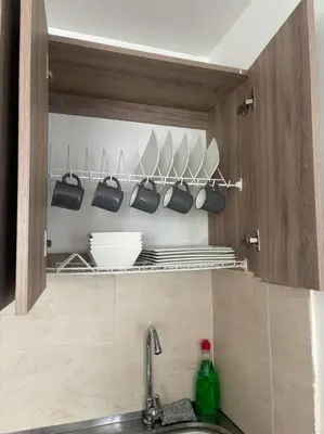 a kitchen with a sink and a shelf with utensils at Apartamento acogedor cerca al Cable in Manizales