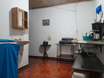a kitchen with a counter and a sink in a room at Casa del Rio Low cost in Honda