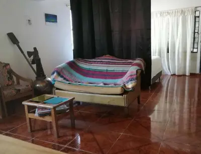 a living room with a bed and a table at Casa del Rio Low cost in Honda