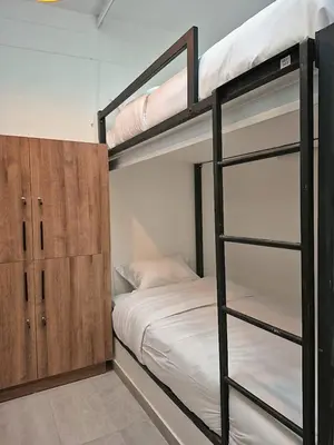 a bedroom with two bunk beds and a closet at Hostal The Nest By Ulivin in Manizales