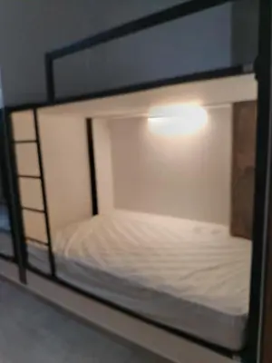 a bunk bed with a light on top of it at Hostal The Nest By Ulivin in Manizales
