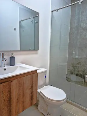 a bathroom with a toilet and a sink and a shower at Hostal The Nest By Ulivin in Manizales