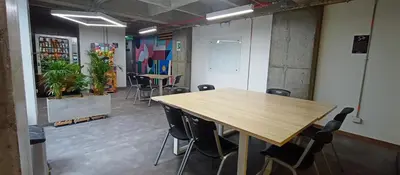 a conference room with a wooden table and chairs at Hostal The Nest By Ulivin in Manizales