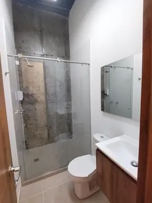 a bathroom with a shower and a toilet and a sink at Hostal The Nest By Ulivin in Manizales