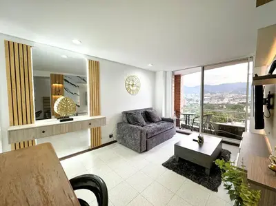 a living room with a couch and a table at Exclusivo apartamento en Poblado con AC a 1 min Provenza in Medellín