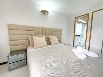 a bedroom with a large bed with two pillows at Exclusivo apartamento en Poblado con AC a 1 min Provenza in Medellín