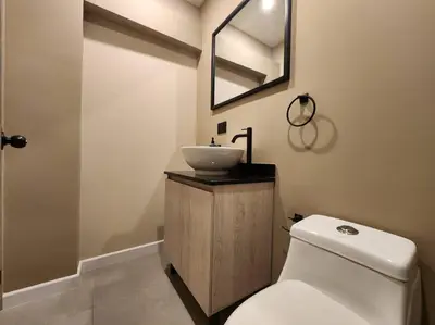 a bathroom with a white toilet and a sink at Loft 10, Suite Parque del Poblado 204 in Medellín